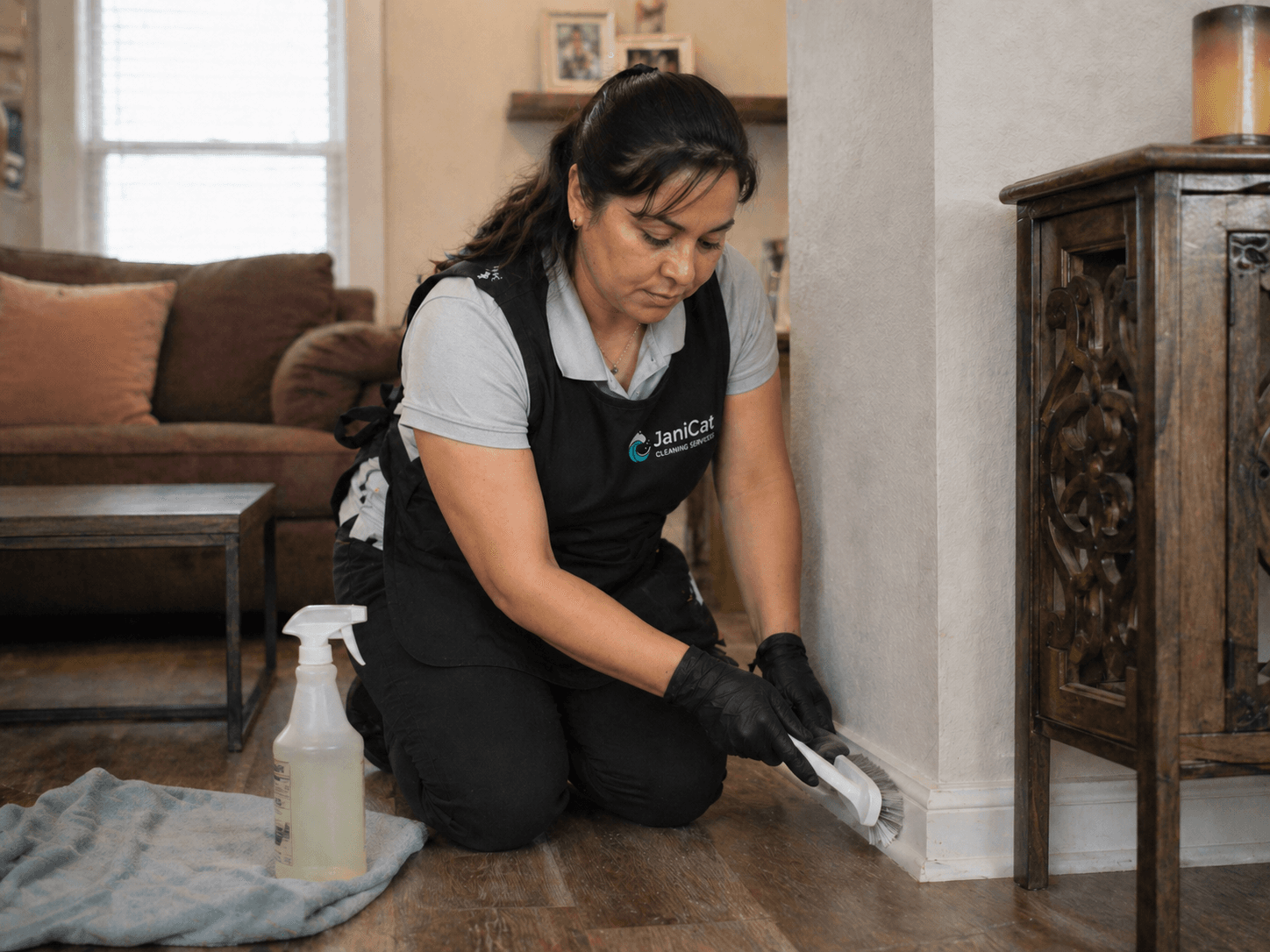 Janicat team member deep-cleaning a baseboard